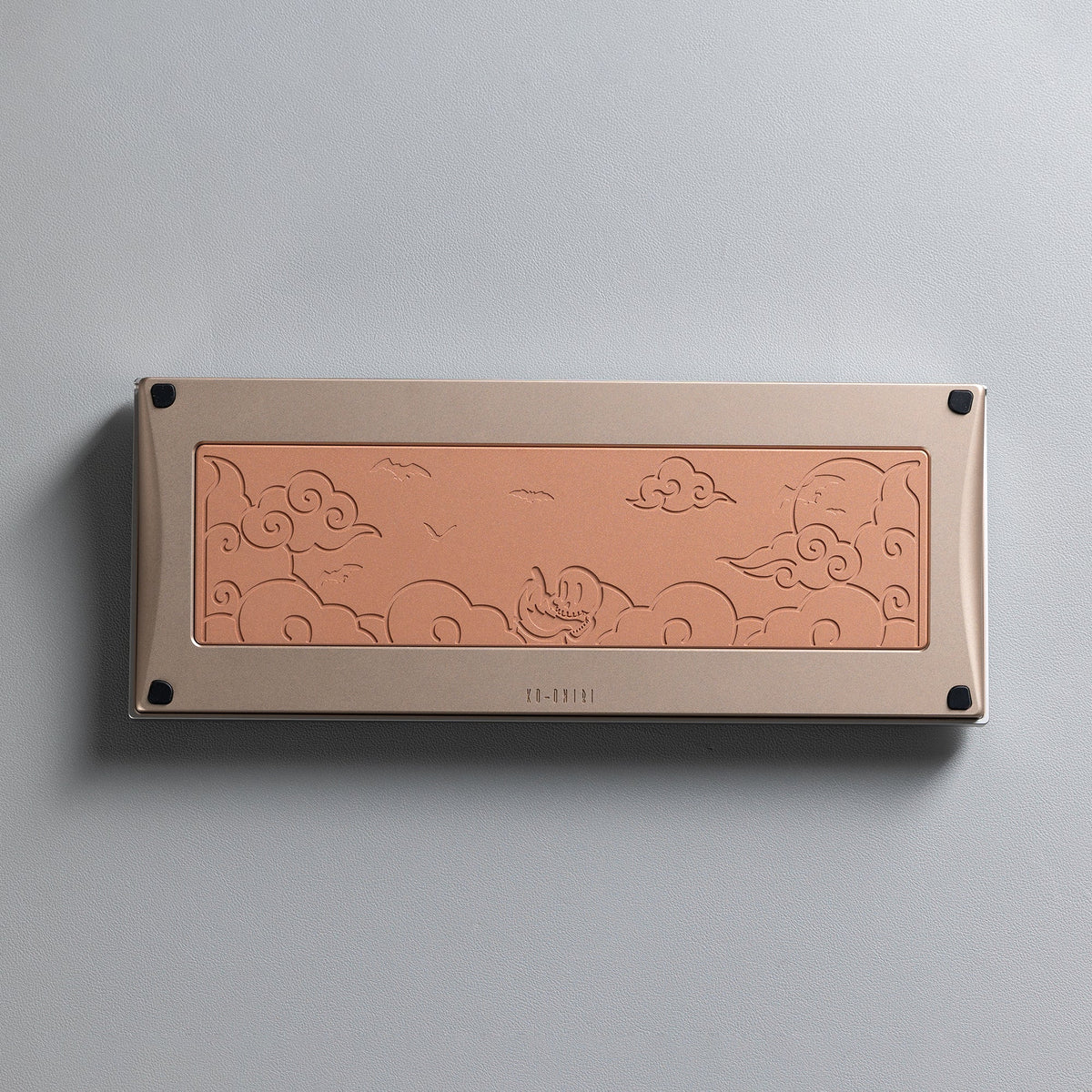 KBDFans KO-Onibi 60% keyboard kit, underside with a copper-toned bottom panel and an embossed cloud motif
